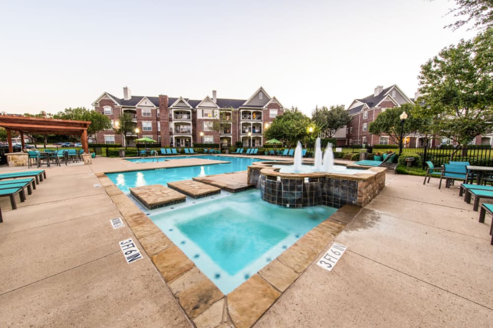 Pool deck and hot tub area with water features at Marquis at Silver Oaks in Grapevine, Texas