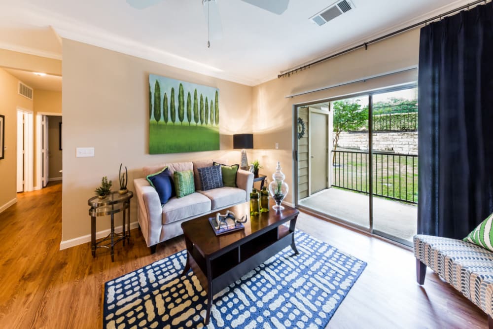 Well-decorated living room with private balcony at Marquis at Canyon Ridge in Austin, Texas