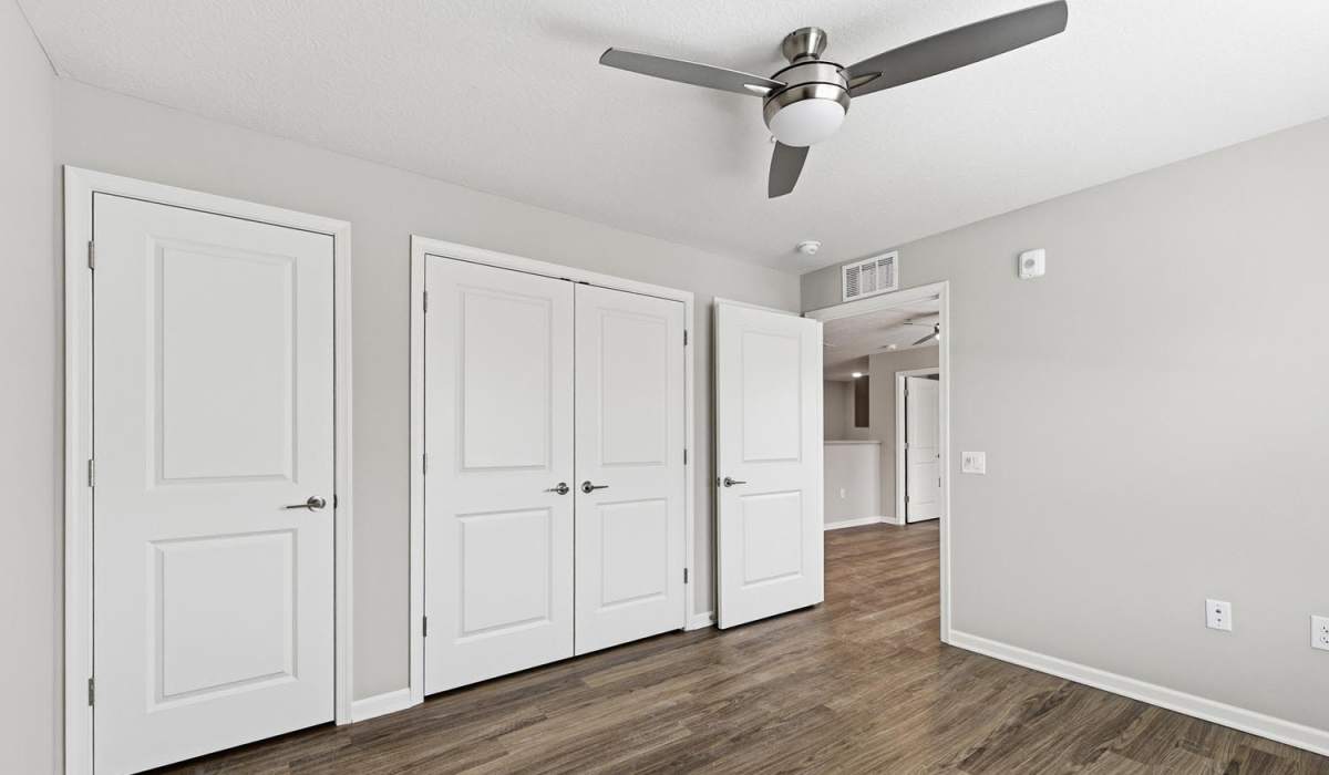 A bedroom with a ceiling fan and wood-style flooring at Granville Woods Lofts II in Columbus, Ohio
