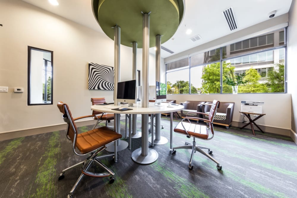 Executive business center with multiple workstations in center of room at Marq Uptown in Austin, Texas