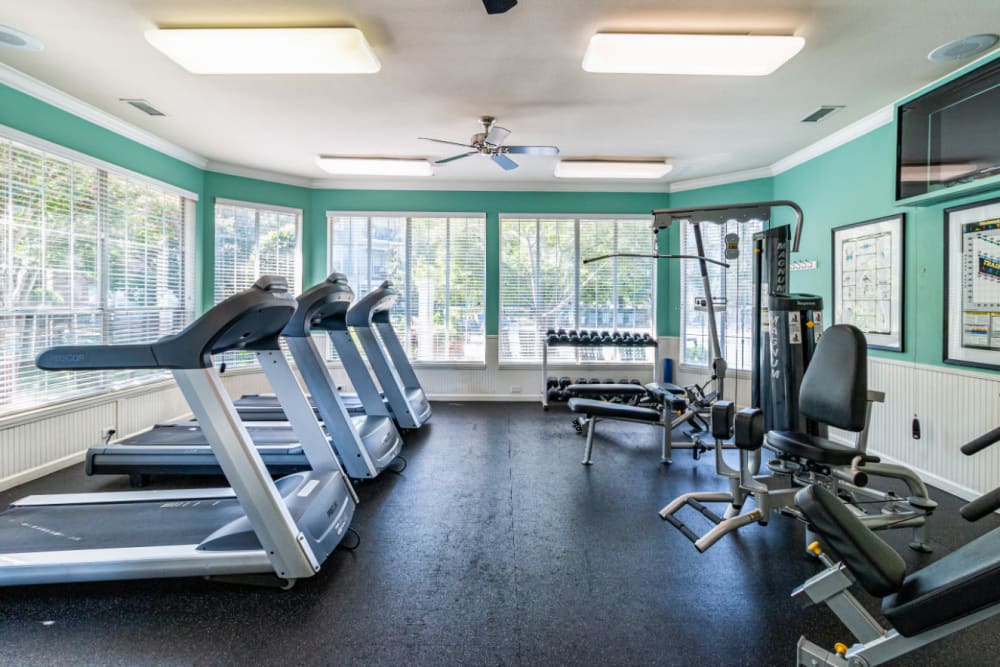 Treadmills and weight machines in fitness room at Marquis of Carmel Valley in Charlotte, North Carolina