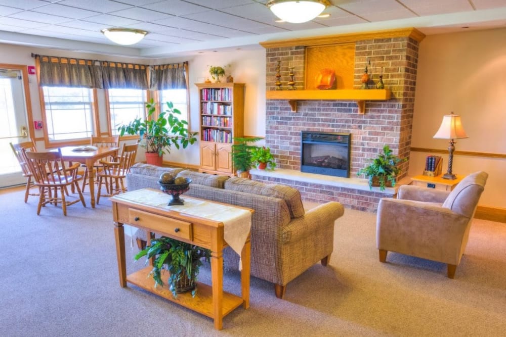 Common area with fireplace and seating at Addington Place of Burlington in Burlington, Iowa