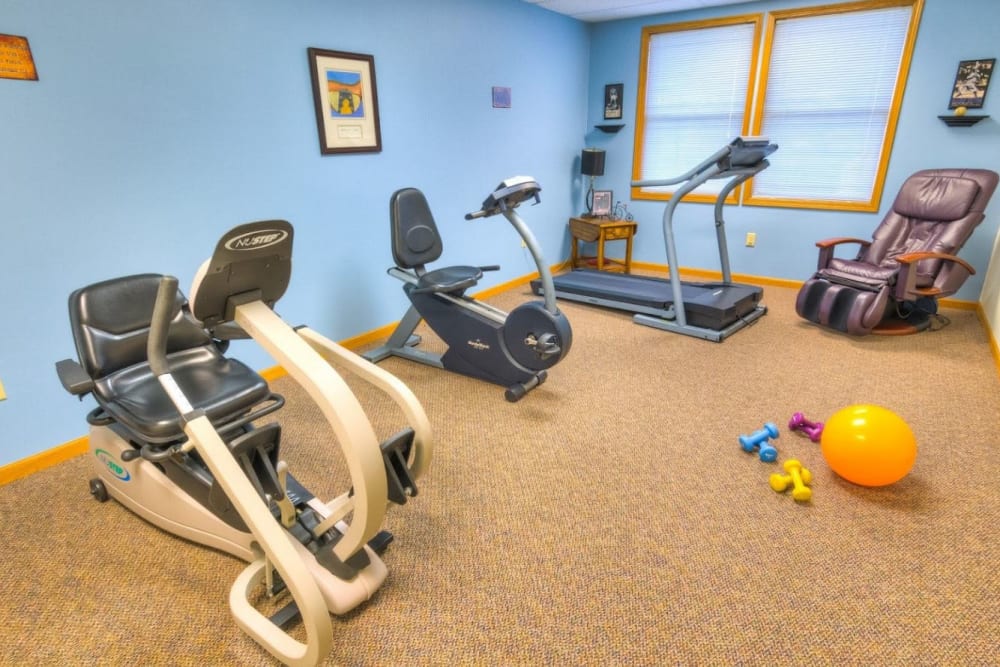 Physical therapy room with massage chair and exercise equipment at Addington Place of Fairfield in Fairfield, Iowa