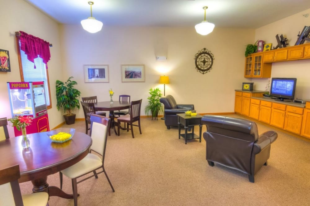 Common area with a TV and popcorn machine at Addington Place of Fort Madison in Fort Madison, Iowa