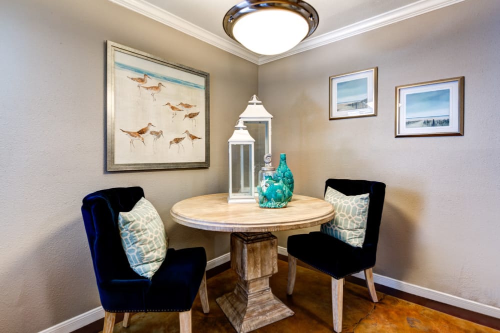 Dining table with chairs in corner with round light above at Austin Midtown in Austin, Texas