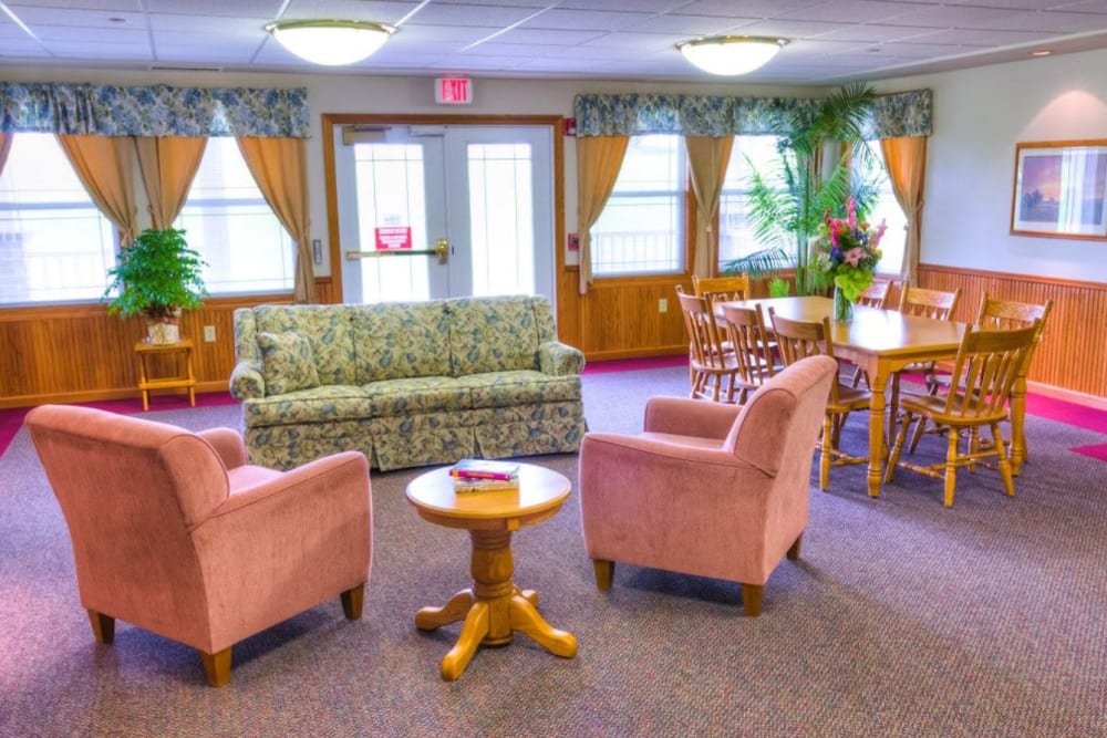 Common area with sofa and two chairs at Addington Place of Mount Pleasant in Mt Pleasant, Iowa