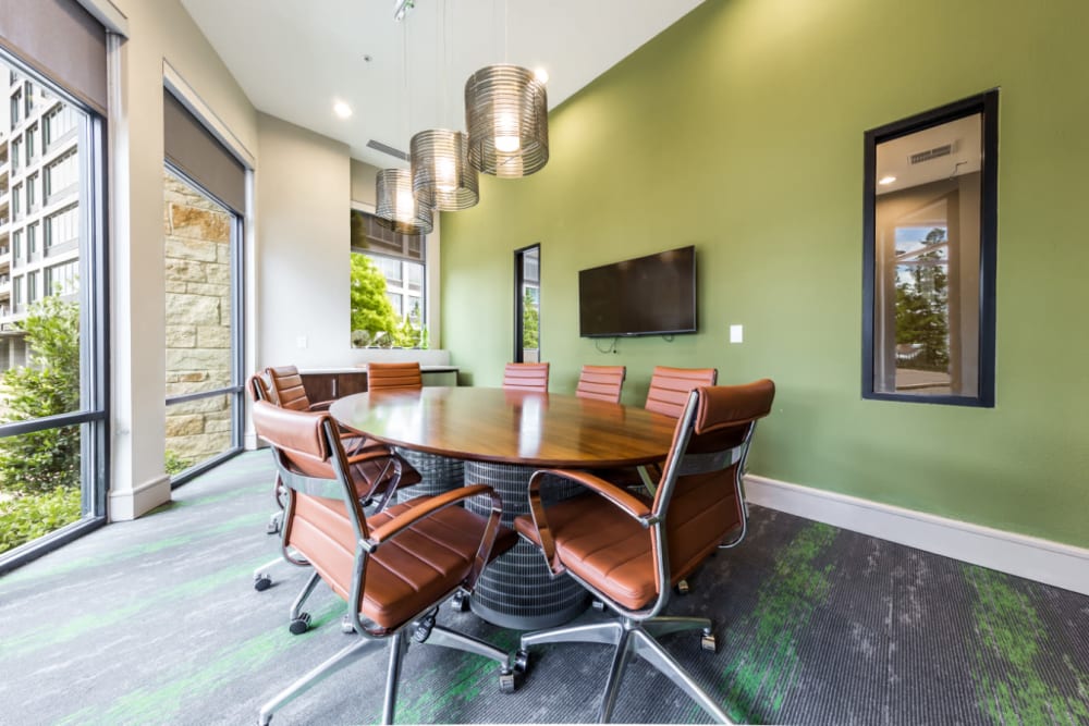 Private business meeting room with television monitor and large windows at Marq Uptown in Austin, Texas