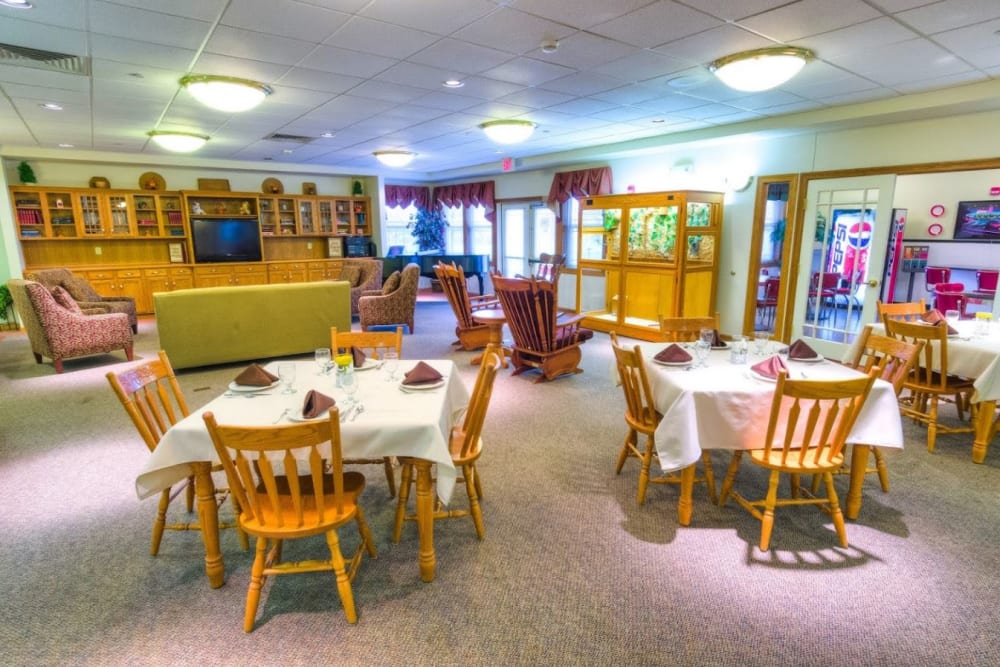 Common area with dining tables and sofa style seating at Addington Place of Fairfield in Fairfield, Iowa