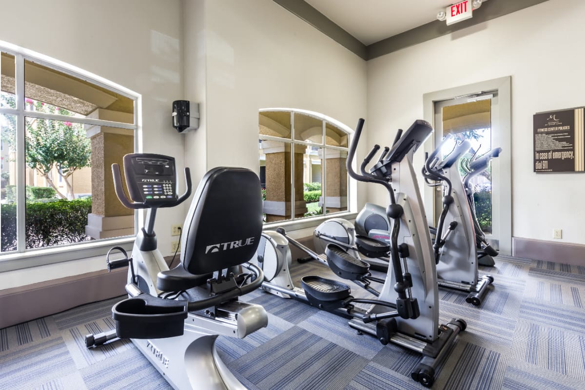 Exercise bike and elliptical machines in fitness room at Marquis at Clear Lake in Webster, Texas