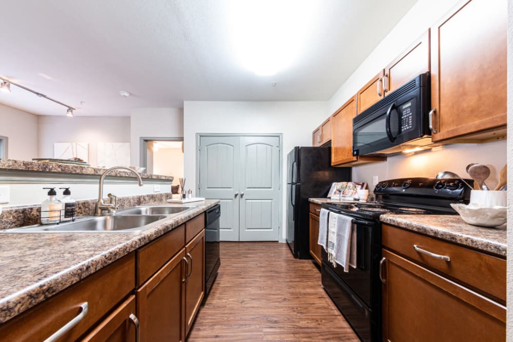 Kitchen with granite counters at Marquis at Katy in Katy, Texas