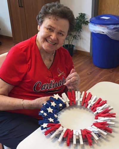 Resident making a wreath look like the American flag at Garden Place Waterloo in Waterloo, Illinois.