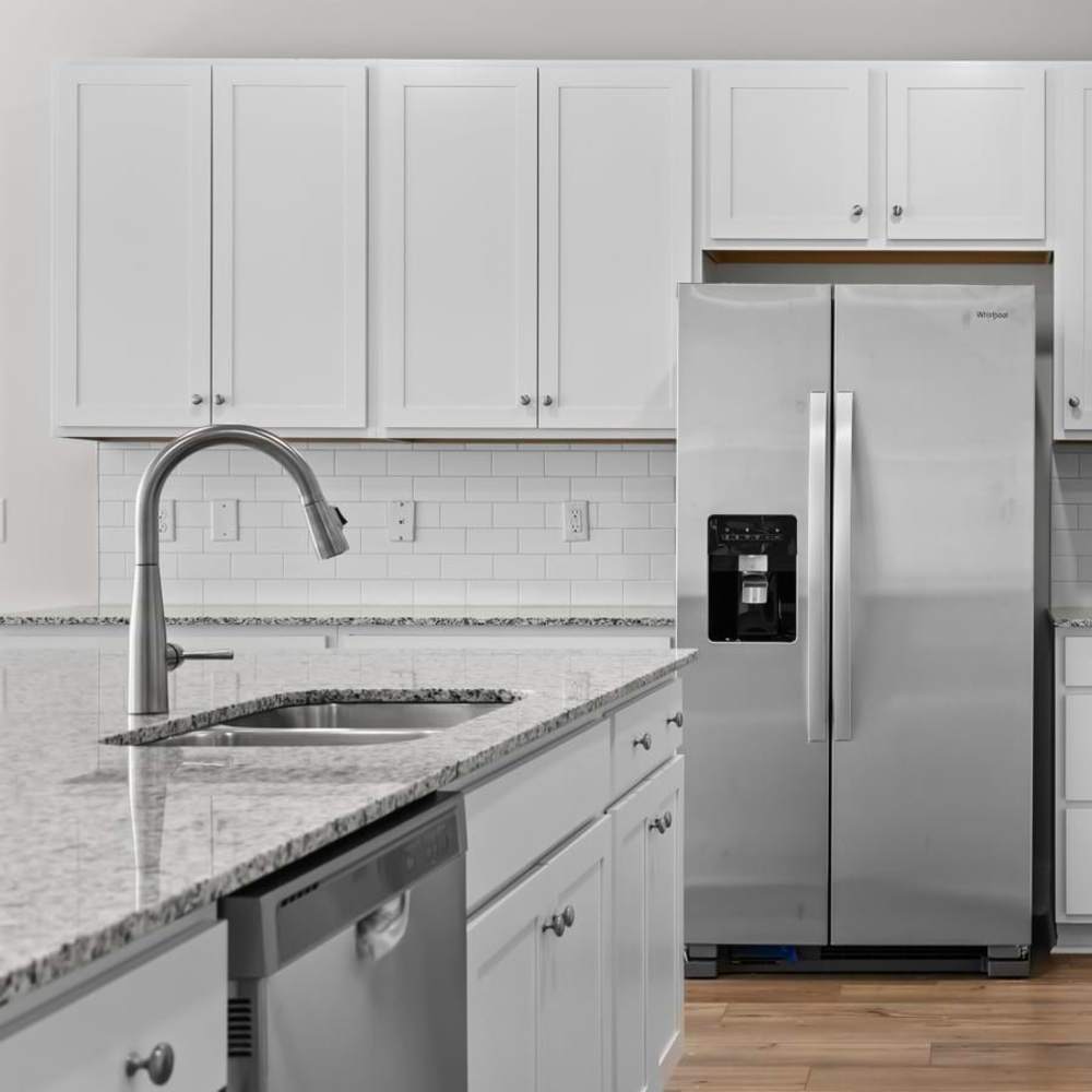 Stainless steel refrigerator with white cabinets at Chamberlain Pines in Summerville, South Carolina