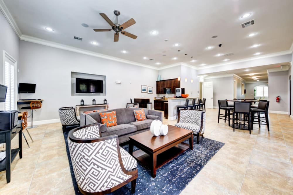 Community clubhouse with seating area, kitchen, and workstation area at Marquis at Silver Oaks in Grapevine, Texas