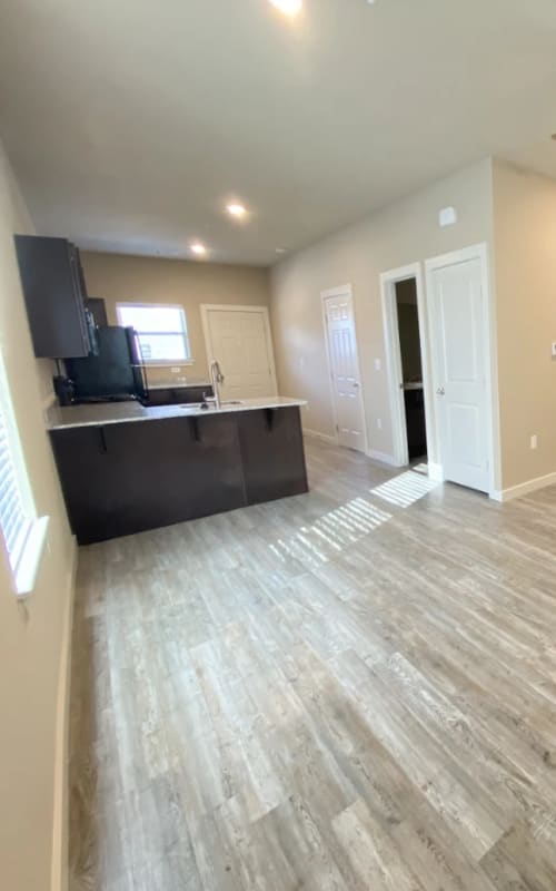 Model kitchen with wood flooring at Atlas at Cabot in Cabot, Arkansas