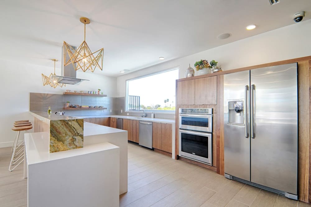 Model kitchen with a large fridge at Angelene Apartments in West Hollywood, California