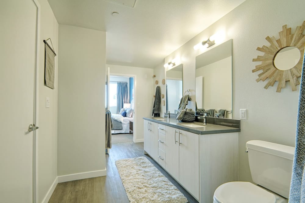 Model bathroom with a large vanity at Angelene Apartments in West Hollywood, California