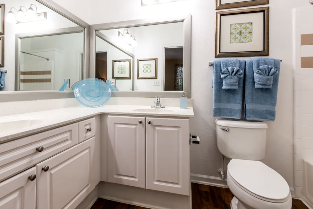 Bright bathroom with large mirrors and double sink at Marquis at Sugarloaf in Duluth, Georgia