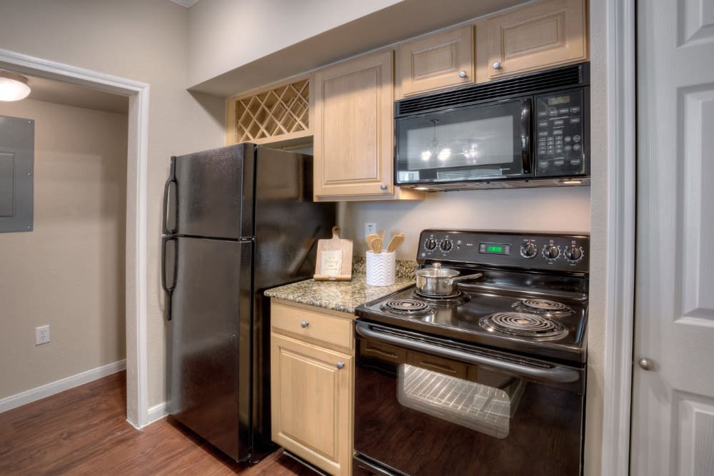Kitchen with granite counters at Marquis Bandera in San Antonio, Texas