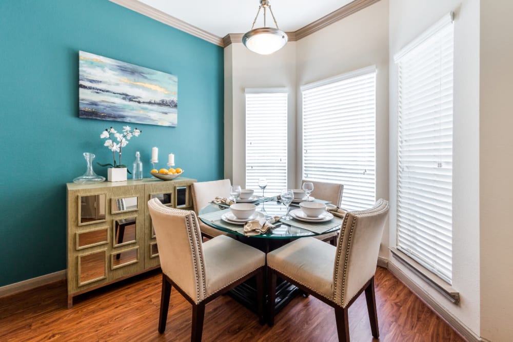 Bright dining area with multiple windows and wood flooring at Marquis on Park Row in Houston, Texas