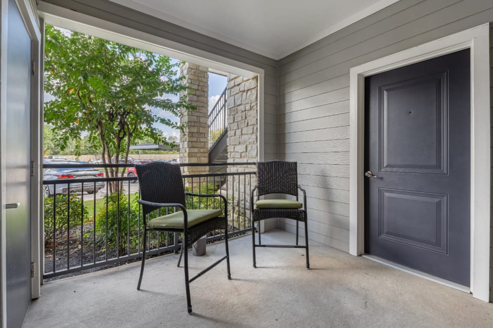 Roomy private balcony with sitting chairs at Marquis at Sugar Land in Sugar Land, Texas