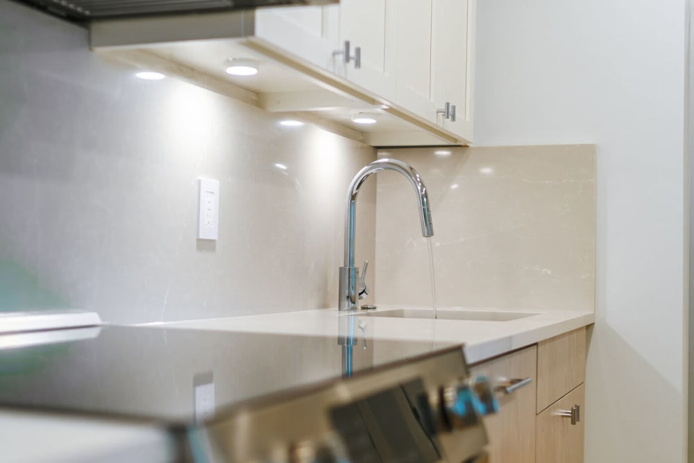 Glass top stove and stainless-steel sink at 28 Exeter at Newbury in Boston, Massachusetts