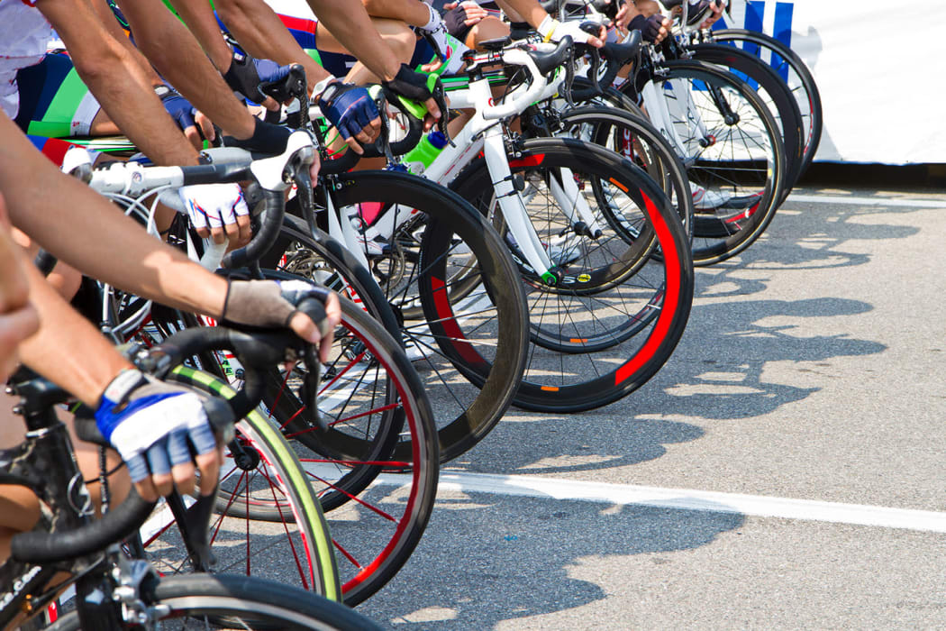Two friends riding bikes together at Redlands Lawn and Tennis Club in Redlands, California