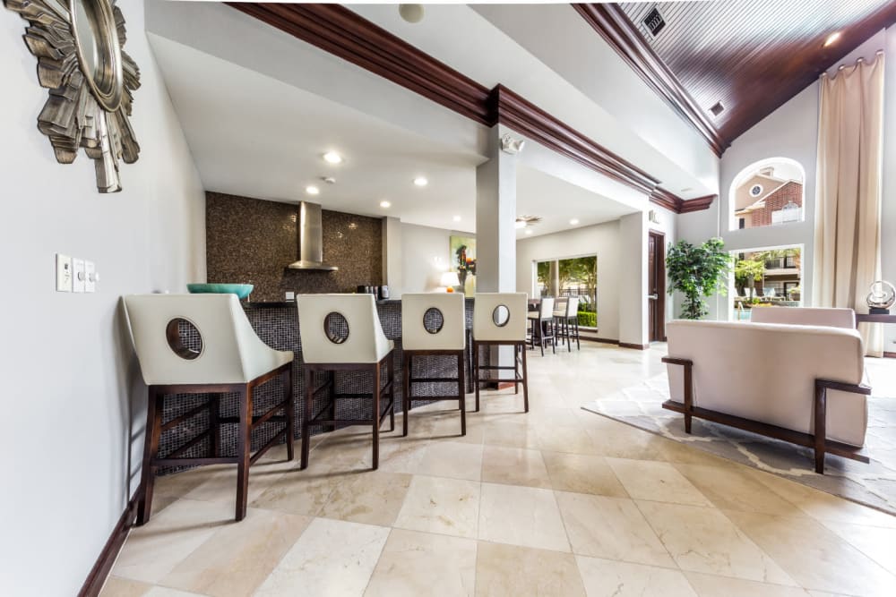 Community clubhouse kitchen area with counter chair stools at Marquis on Park Row in Houston, Texas