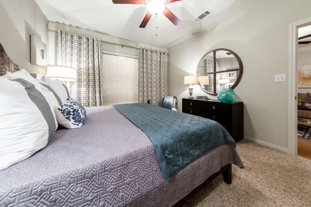 Carpeted bedroom with window at Marquis at the Reserve in Katy, Texas