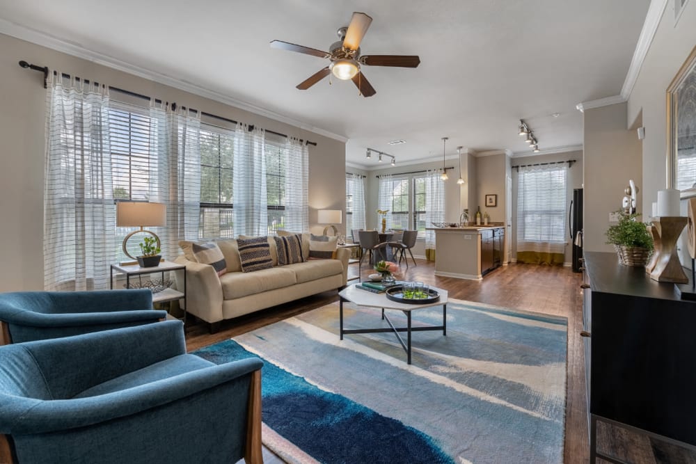 Spacious and comfortable living area overlooking kitchen and dining area at Marquis at Sugar Land in Sugar Land, Texas