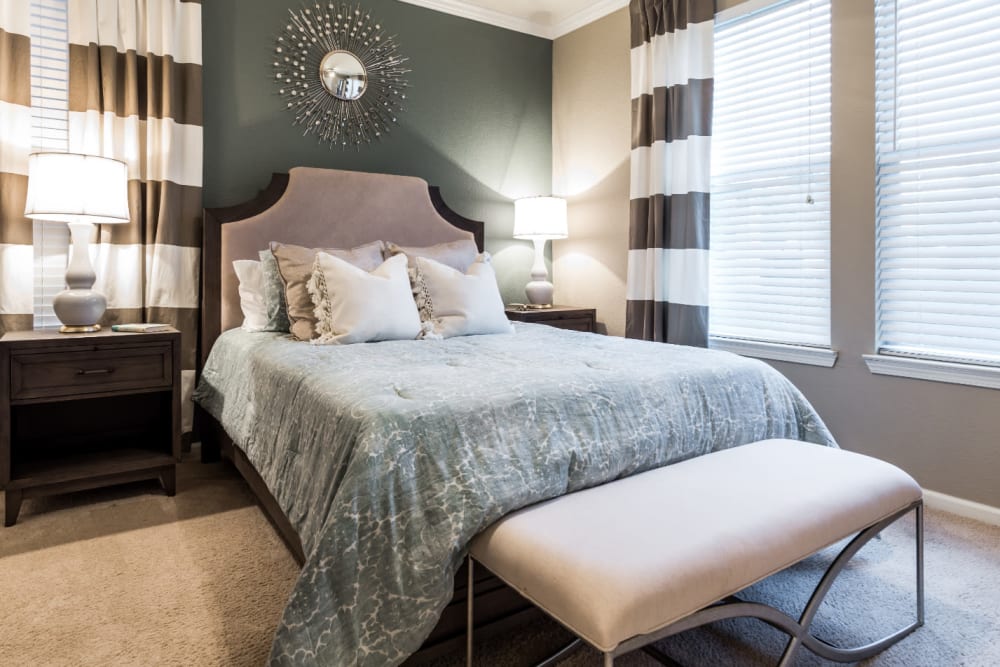 Modern style bedroom with multiple windows at Marquis at The Cascades in Tyler, Texas