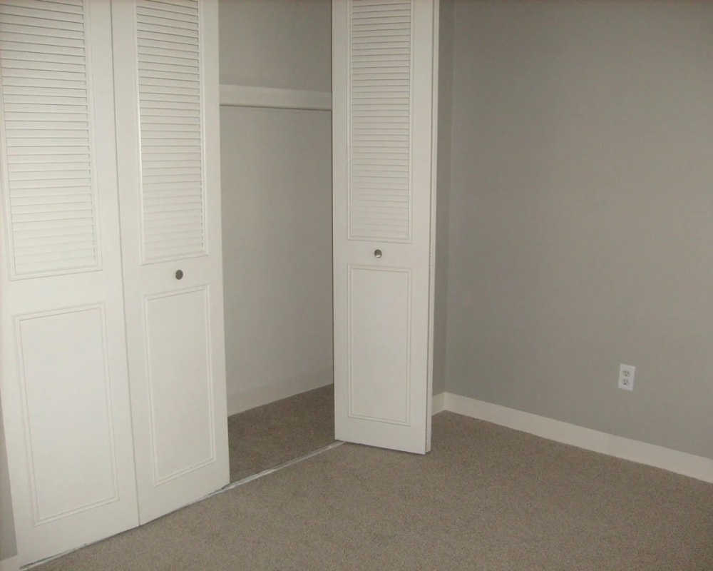 Bedroom with carpet and closet at  Park Place Apartments in Roseville, California