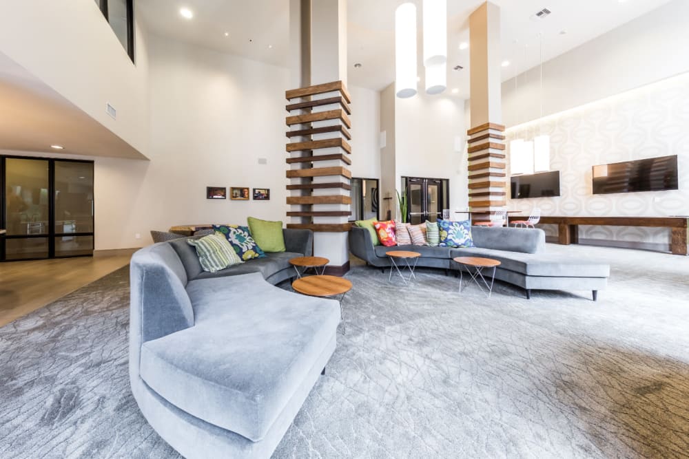 Large sofas with coffee tables in community clubhouse room at Marq Uptown in Austin, Texas