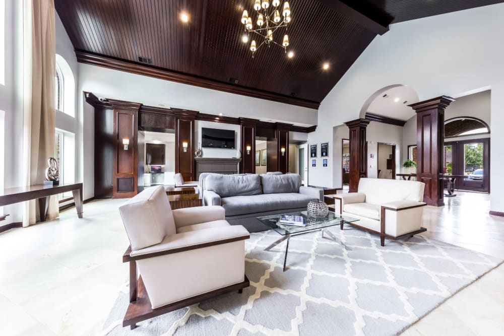 Community clubhouse main sitting area with couches and vaulted ceilings at Marquis on Park Row in Houston, Texas