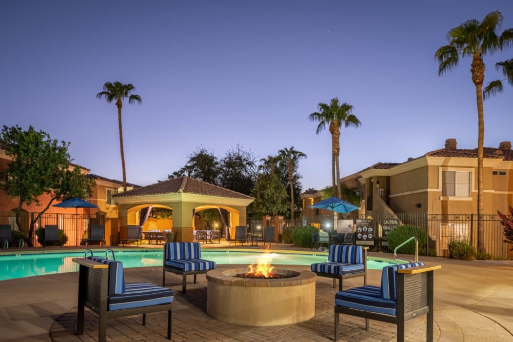 Poolside firepit with chairs at sunset at Alante at the Islands in Chandler, Arizona