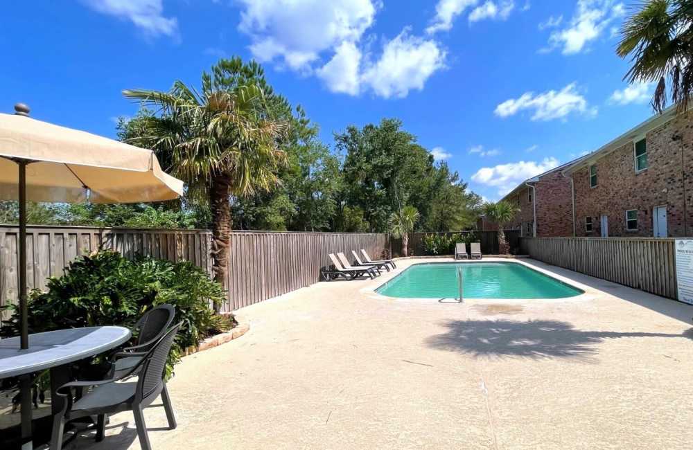 Sparkling pool with sundeck and lounge area at Creekwood Townhomes in Hammond, Louisiana