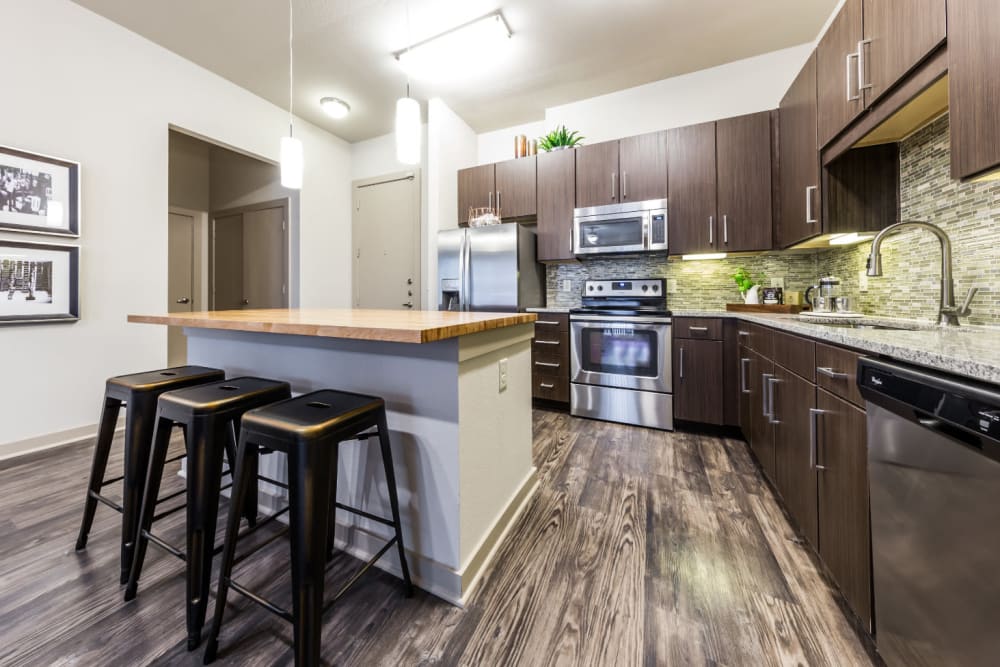 Spacious kitchen with kitchen island and counter stools at Marq Uptown in Austin, Texas