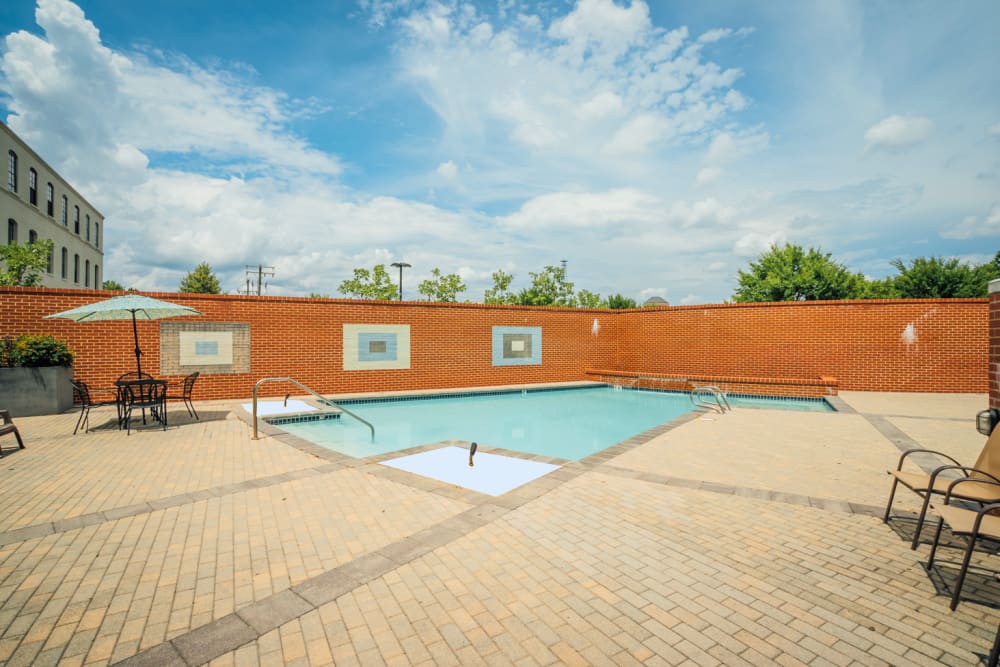 Swimming pool with outdoor seating area at Perry Street Lofts in Petersburg. VA
