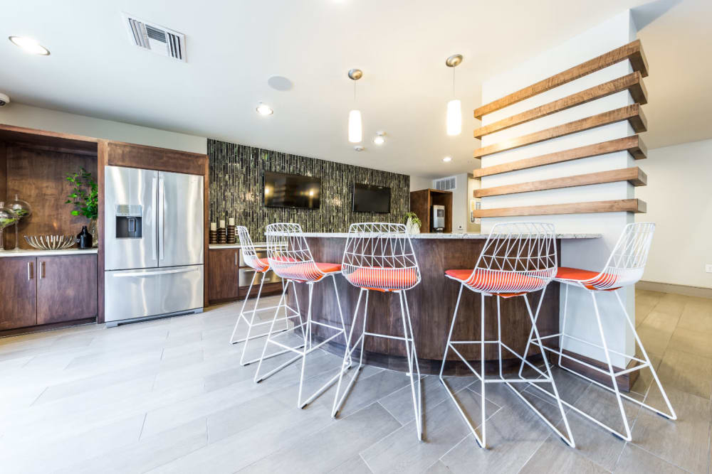 Kitchen island with tall counter chairs in community clubhouse at Marq Uptown in Austin, Texas
