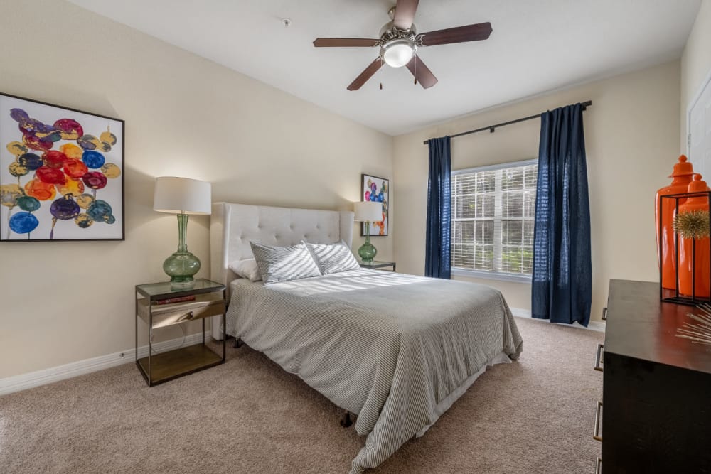 Carpeted spacious bedroom with big window at Marquis at Kingwood in Kingwood, Texas