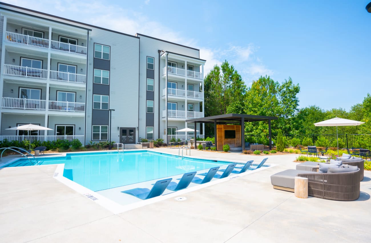 Sunny day by the pool showing the exterior of the community