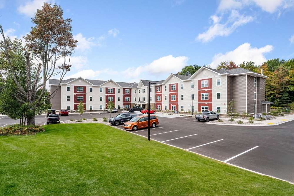 Modern apartment community with landscaped green space and ample parking spaces at Black Rock Crossing in Marquette, Michigan