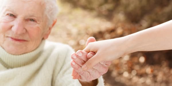 Resident receiving help standing up at The Residences on Forest Lane in Montello, Wisconsin