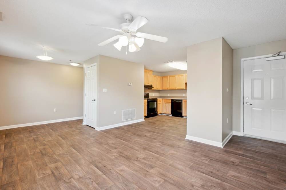 Living room with connecting kitchen space at Fellwood I in Savannah, Georgia