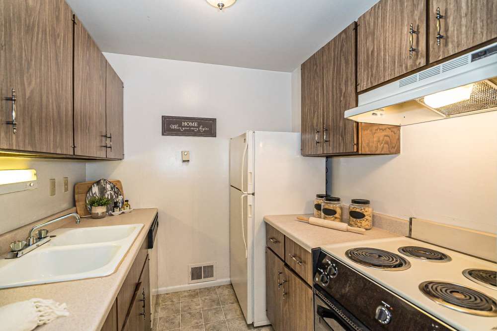 Kitchen with refrigerator at Pear Tree in Saint Ann. MO