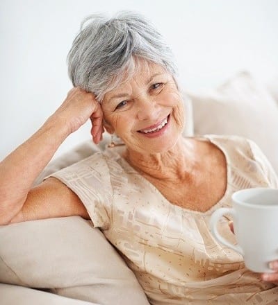 A woman enjoying her tea at Brightwater Senior Living of Linden Ridge in Winnipeg, Manitoba