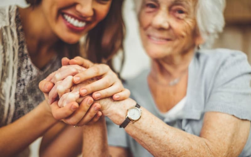 Residents holding hands with daughter at Grand Villa of St. Petersburg in St. Petersburg, Florida