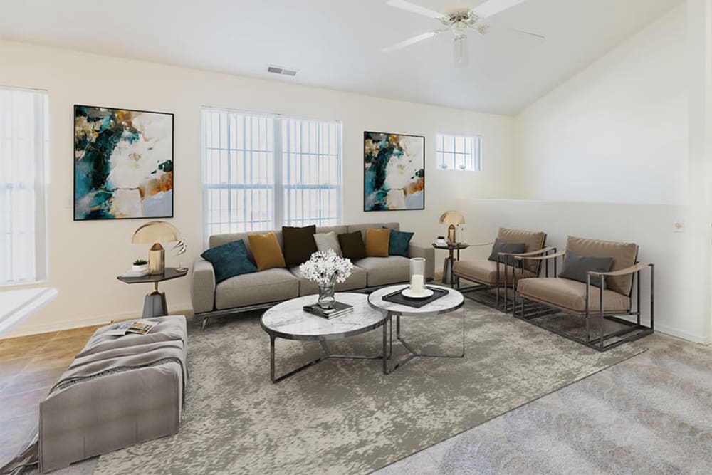 Naturally well-lit living room with a ceiling fan at Avon Commons in Avon, New York