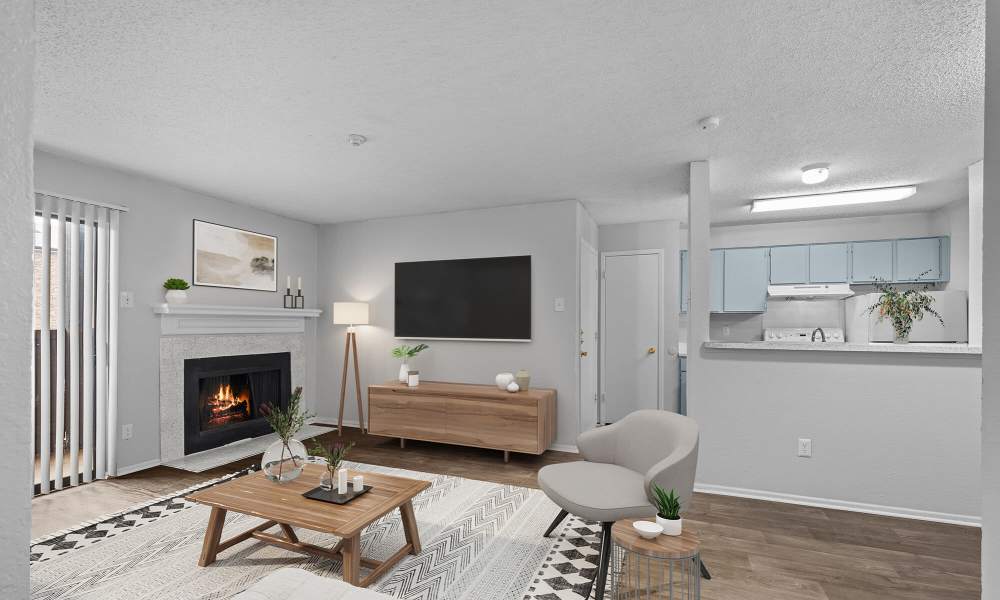 Well-furnished iving room with wood flooring at Pine Oaks Apartments in Mesquite, Texas