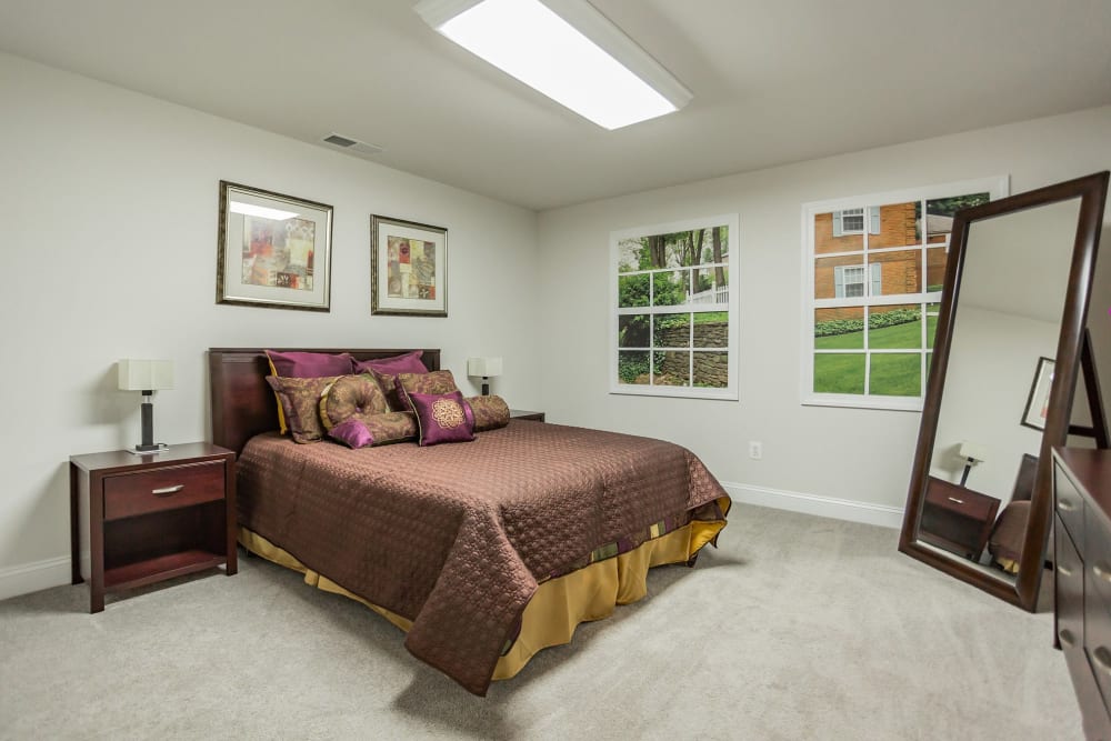 Bedroom with white furniture at Melrose Station Apartments in Elkins Park, Pennsylvania