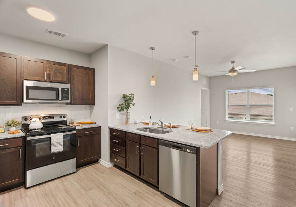 Spacious kitchen with granite countertop at Walnut Springs in Seguin, Texas
